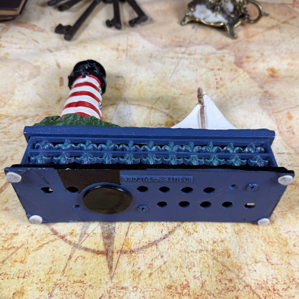 Cast Iron Lighthouse & Sailboat Mechanical Coin Bank | Bits & Pieces