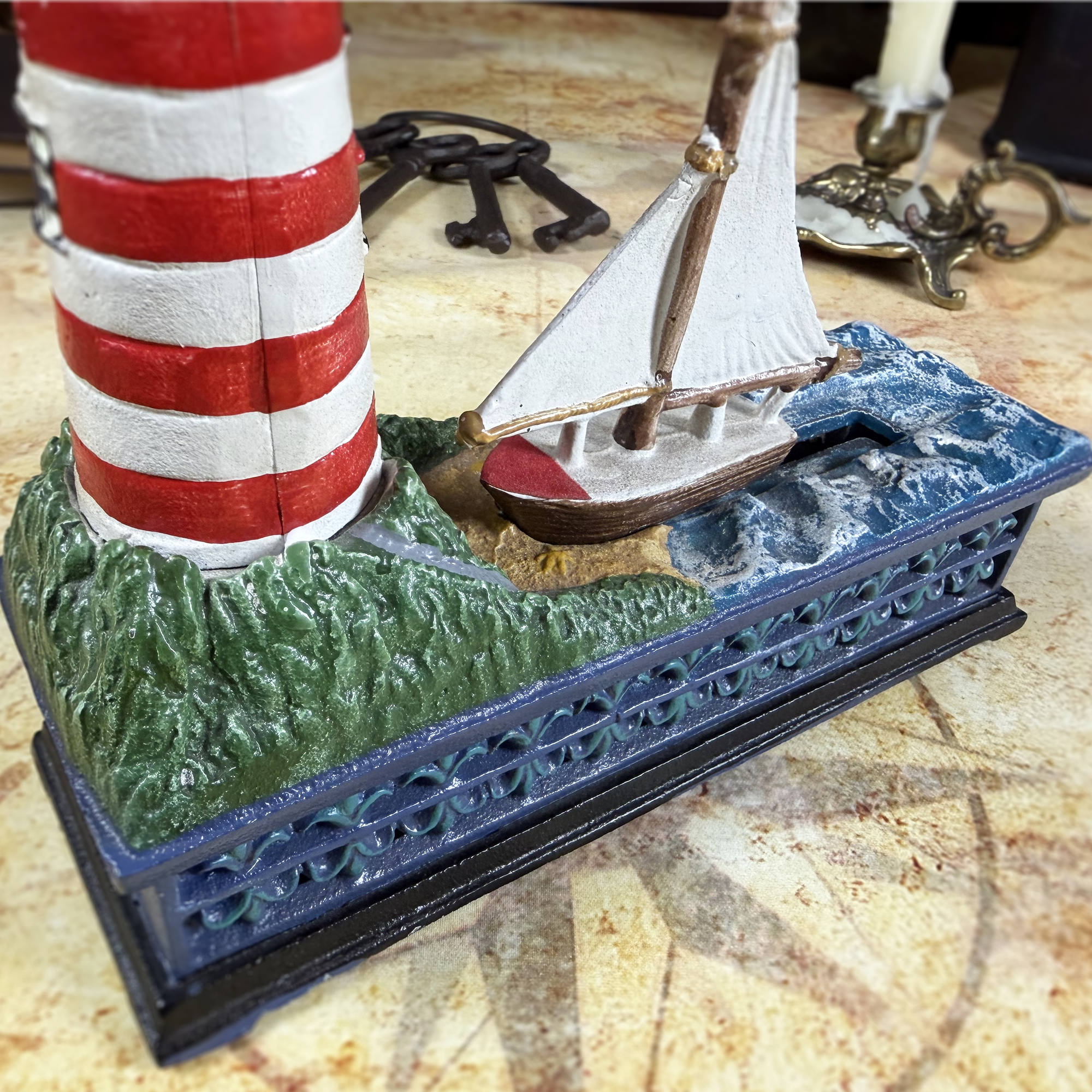 Cast Iron Lighthouse & Sailboat Mechanical Coin Bank | Bits & Pieces