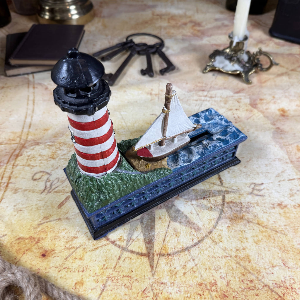Cast Iron Lighthouse & Sailboat Mechanical Coin Bank | Bits & Pieces