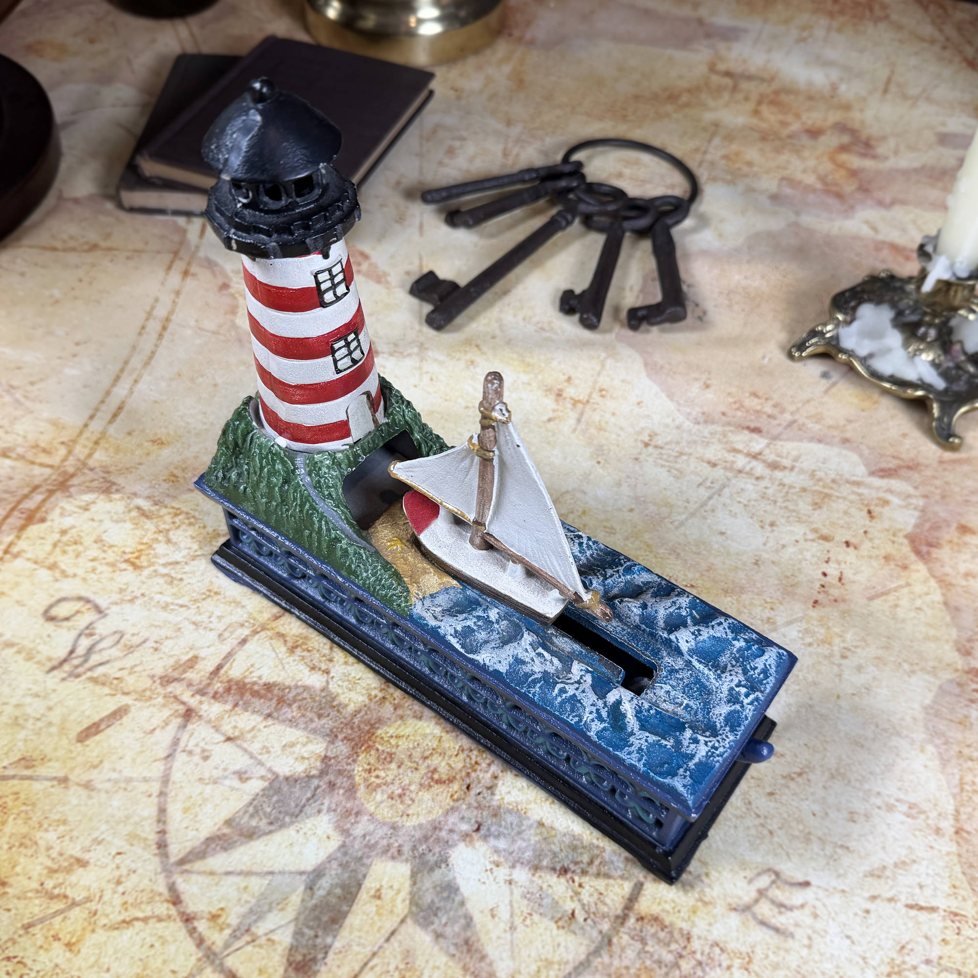 Cast Iron Lighthouse & Sailboat Mechanical Coin Bank | Bits & Pieces