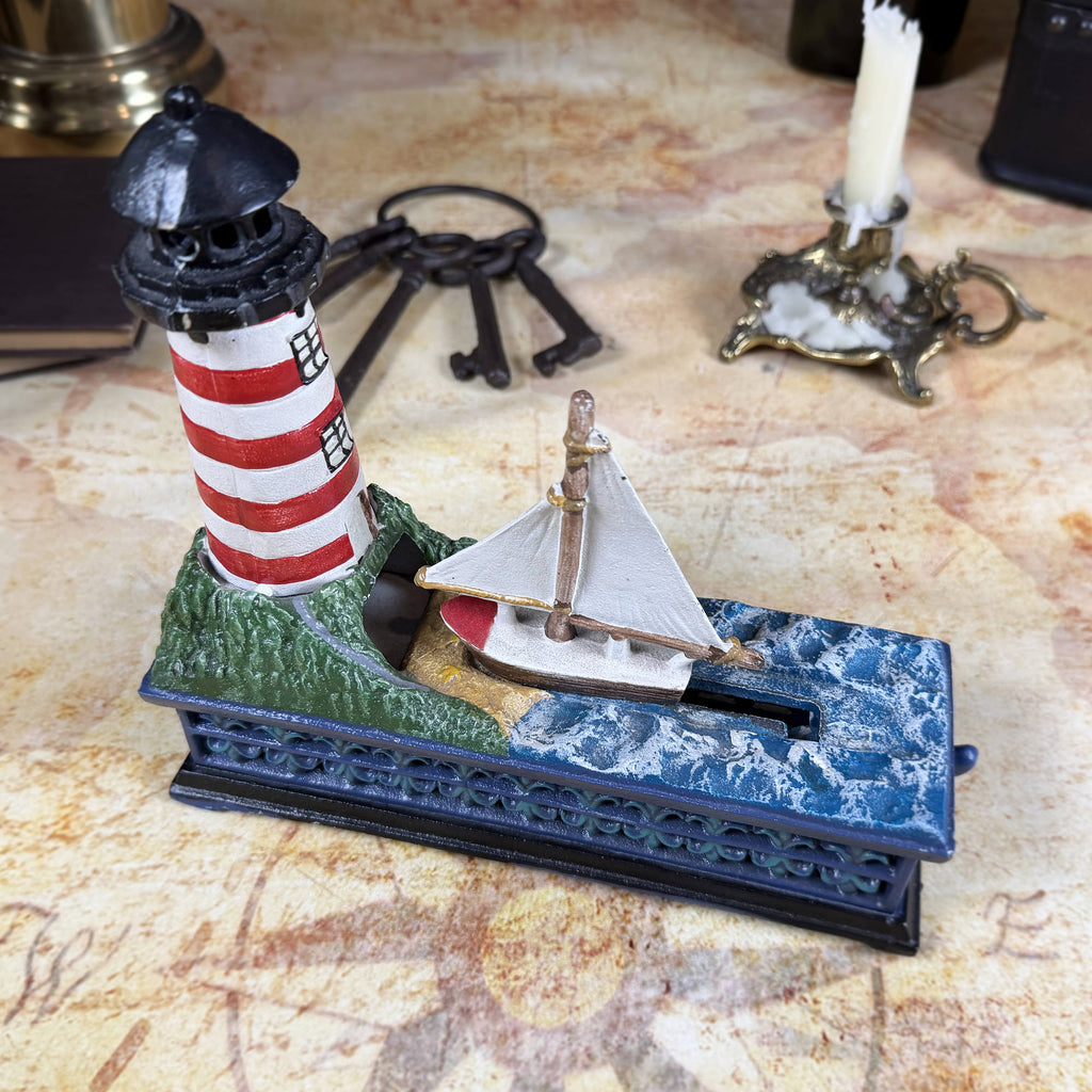 Cast Iron Lighthouse & Sailboat Mechanical Coin Bank | Bits & Pieces