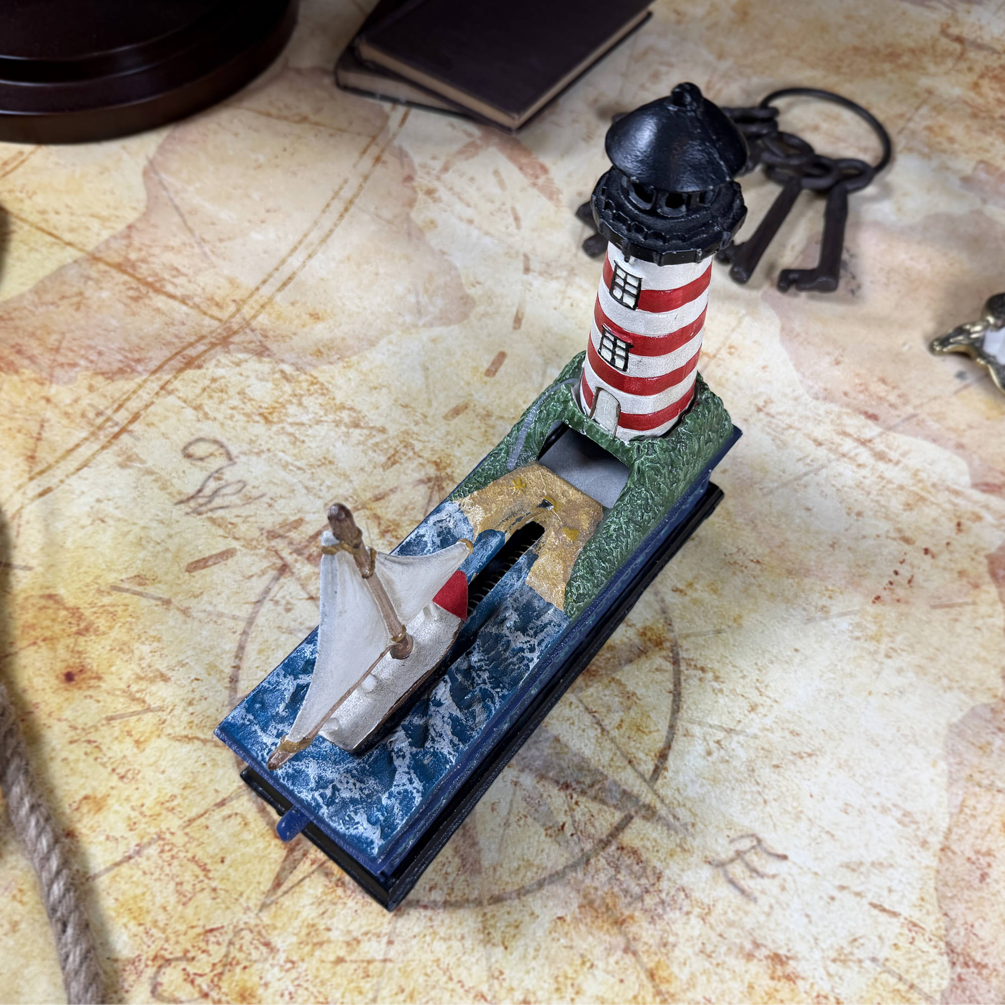 Cast Iron Lighthouse & Sailboat Mechanical Coin Bank | Bits & Pieces