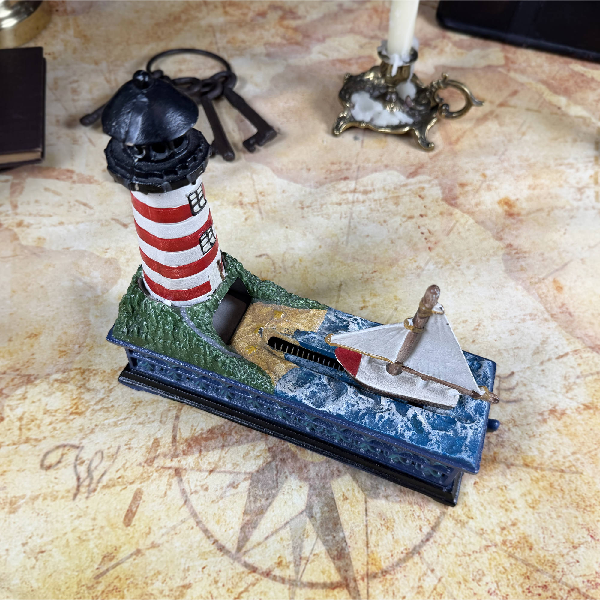 Cast Iron Lighthouse & Sailboat Mechanical Coin Bank | Bits & Pieces