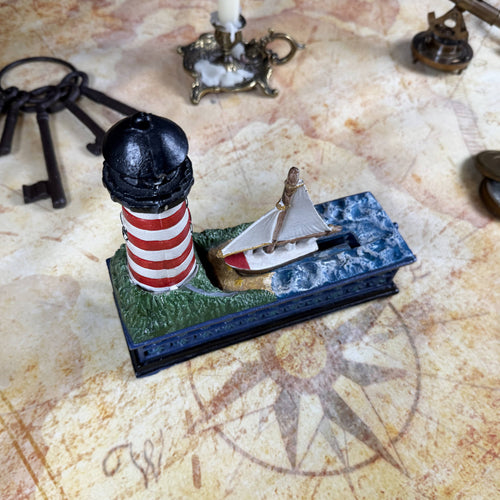 Cast Iron Lighthouse & Sailboat Mechanical Coin Bank | Bits & Pieces